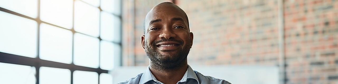 A smiling man in a business shirt