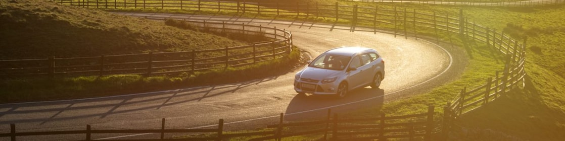 car driving in green field