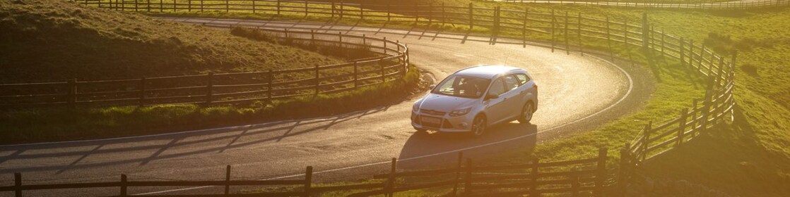 car driving in green field