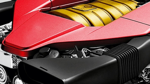 The engine of a car, with red trim and gold middle