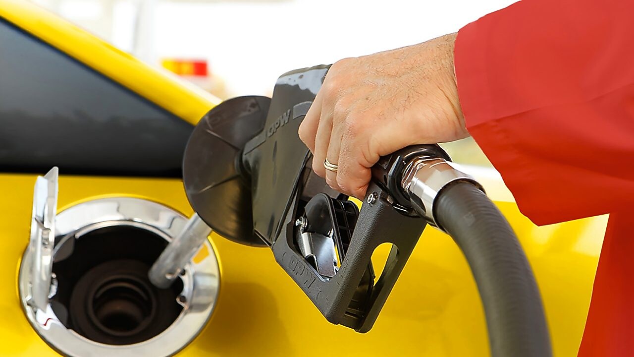 Person filling fuel at fuel station