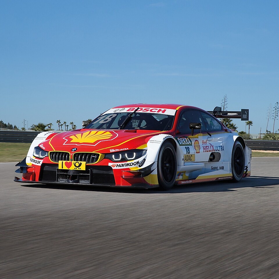 A red and white BMW race car sits on the track, exemplifying the Shell Helix Ultra and BMW’s Premium Technology Partnership