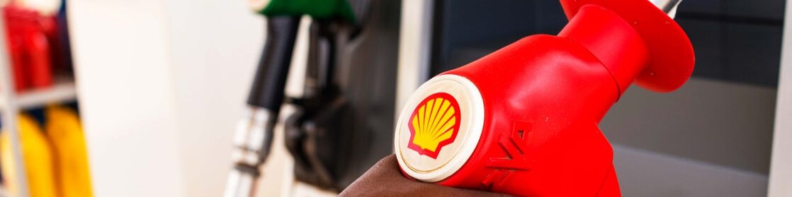 Service attendant holding a fuel nozzle
