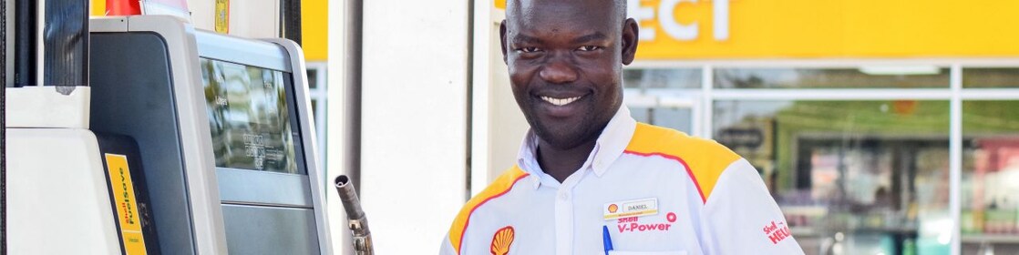 A service champion on the forecourt next to pump
